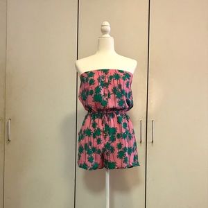 Strapless pink romper with palm tree print